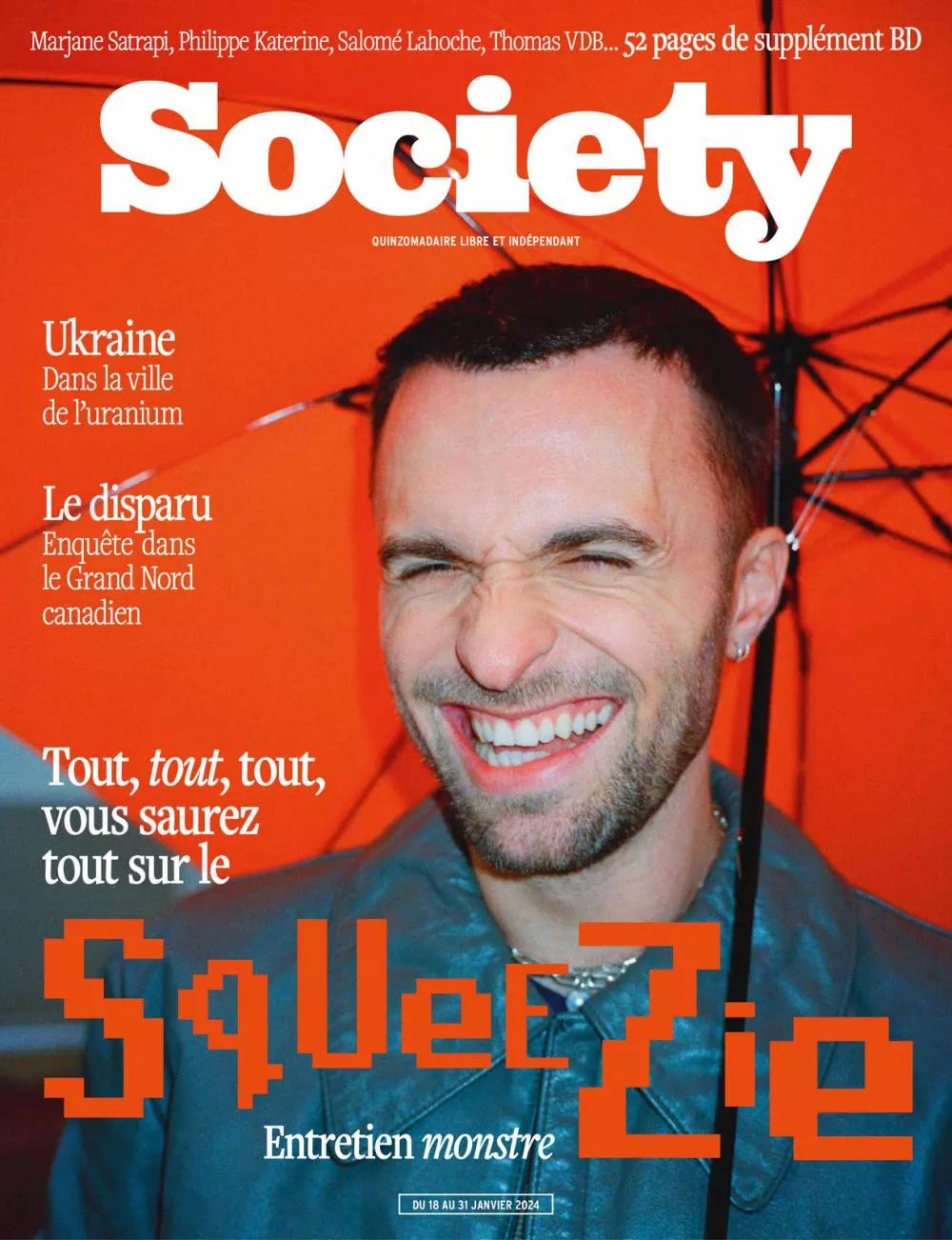 Un homme souriant est photographié sous un parapluie orange. Le magazine "Society" met en avant un entretien avec Squeezie, ainsi que des articles sur l'Ukraine et une enquête dans le Grand Nord canadien.