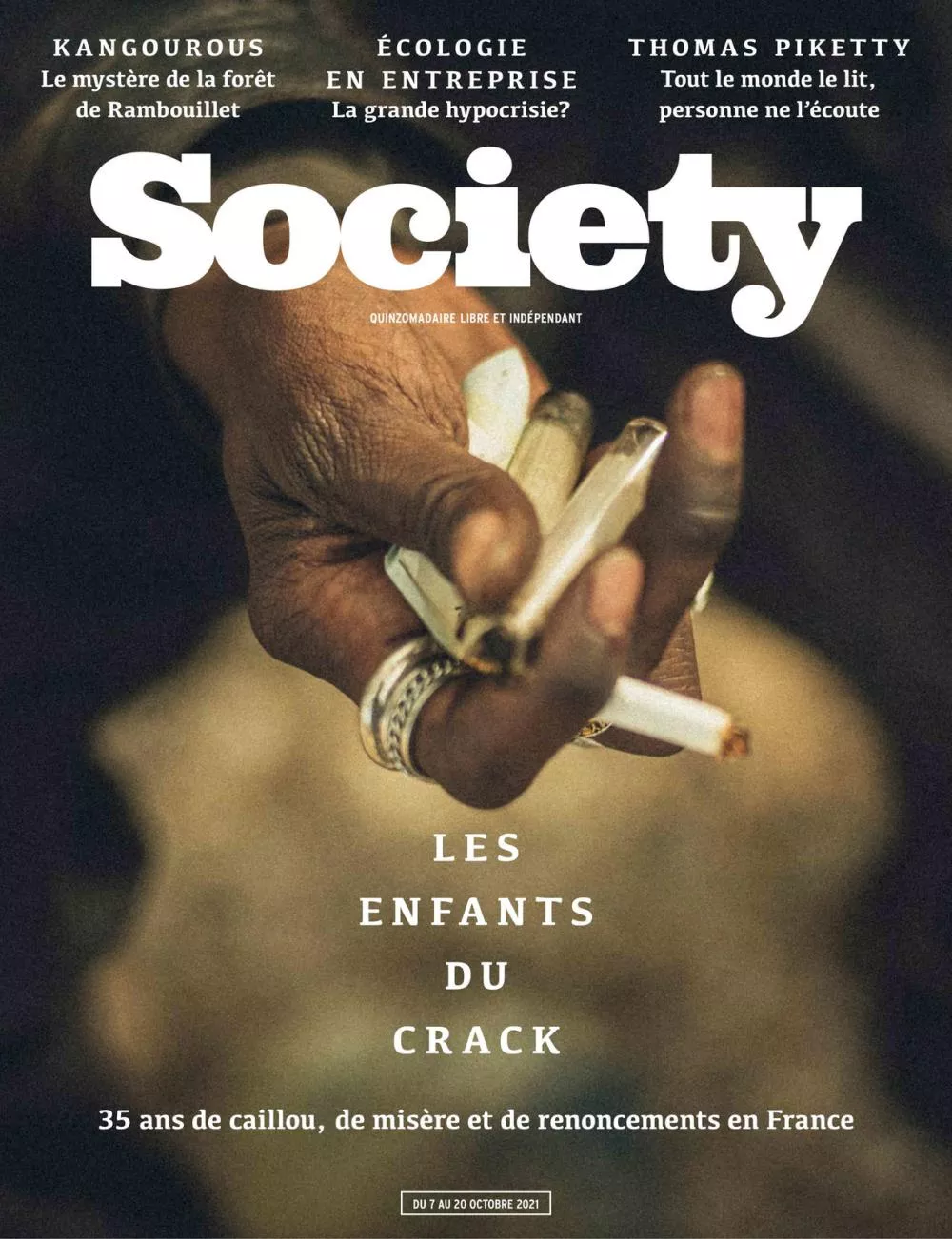 La couverture du magazine "Society" présente une main tenant une cigarette, avec des titres sur des sujets tels que les kangourous à Rambouillet, l'écologie en entreprise, et Thomas Piketty. Le sujet principal est "Les enfants du crack" en France, abordant 35 ans de misère et de renoncements.