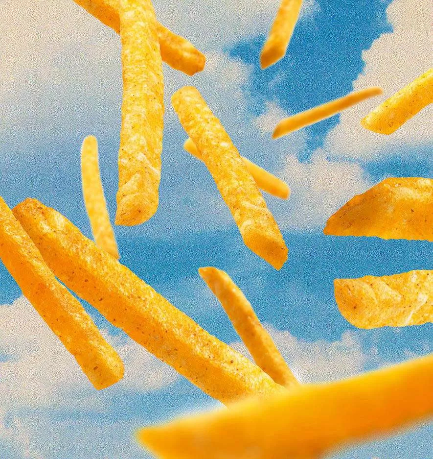 Des frites flottant dans un ciel bleu avec des nuages.