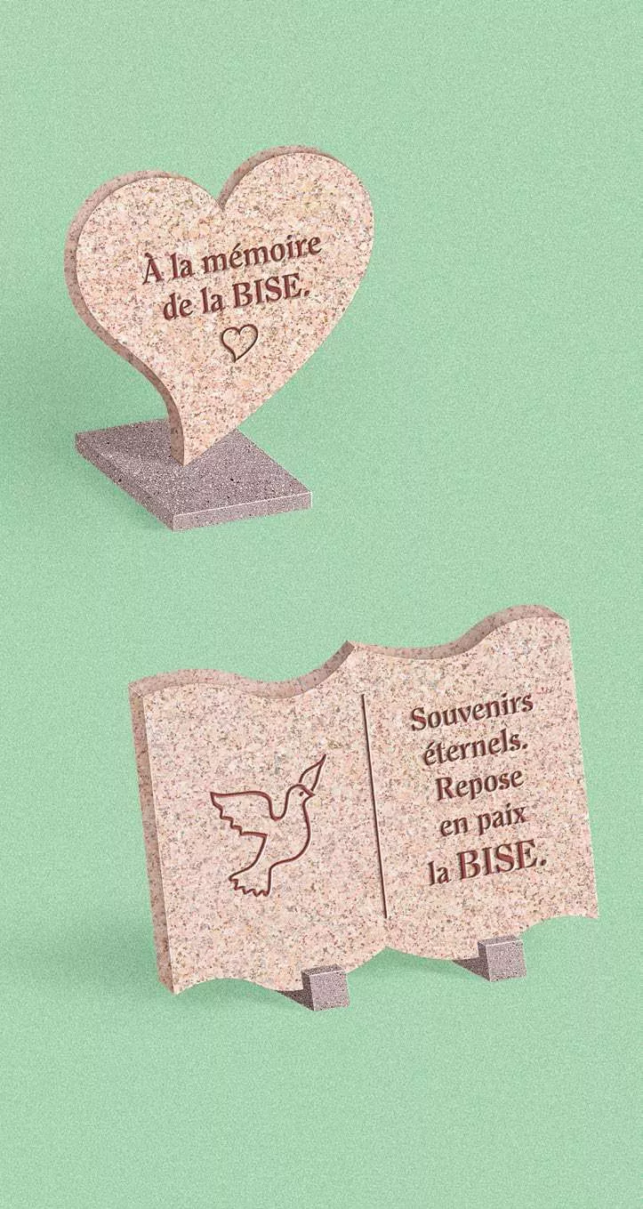Deux pierres tombales en hommage à "la BISE", l'une en forme de cœur et l'autre en forme de livre avec une colombe gravée.